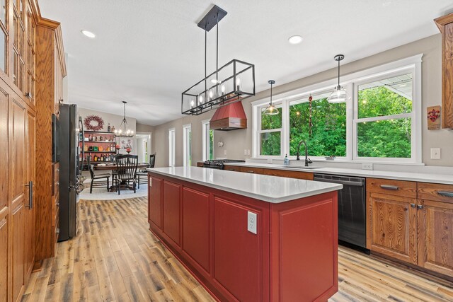 N5887 1110th St, Oak Grove Twp, WI 54021 - kitchen featuring stainless steel dishwasher, light wood-type flooring, a kitchen island, custom range hood, and a chandelier
