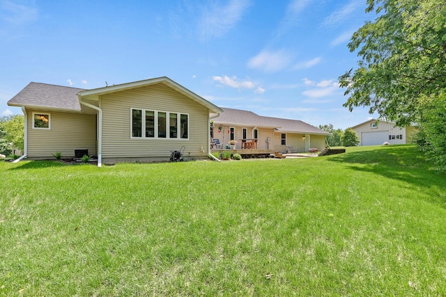 N5887 1110th St, Oak Grove Twp, WI 54021 - back of property featuring a lawn, a detached garage, and a deck