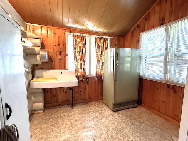 518 Sparrow Ln, Fall Lake Twp, MN 55731 - kitchen featuring freestanding refrigerator, wooden walls, and wood ceiling