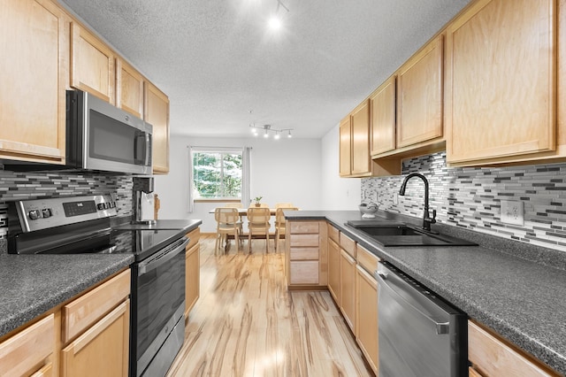 14939 Pinto Ln, Savage, MN 55378 - kitchen with appliances with stainless steel finishes, track lighting, light brown cabinetry, light wood-style floors, and a textured ceiling