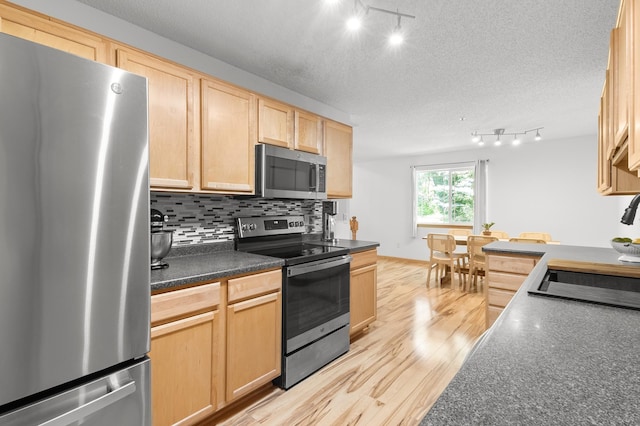 14939 Pinto Ln, Savage, MN 55378 - kitchen featuring appliances with stainless steel finishes, light brown cabinets, light wood-style flooring, rail lighting, and a textured ceiling