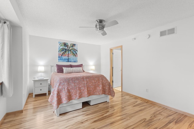 14939 Pinto Ln, Savage, MN 55378 - bedroom featuring light wood-style floors, a textured ceiling, and ceiling fan