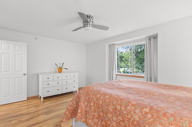 14939 Pinto Ln, Savage, MN 55378 - bedroom with wood finished floors, a ceiling fan, and a textured ceiling