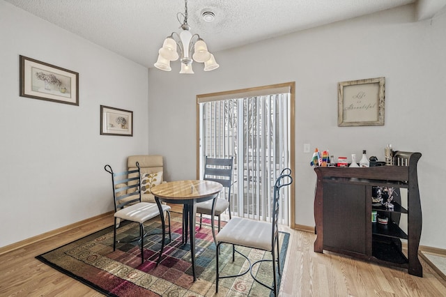6566 Merrimac Ln N, Maple Grove, MN 55311 - dining room with a chandelier, wood finished floors, and a textured ceiling