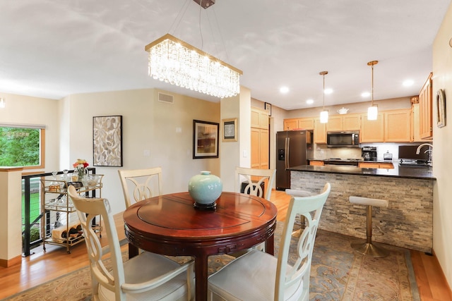 2583 Lost Lake Rd, Mound, MN 55364 - dining room featuring wood finished floors, a chandelier, and recessed lighting