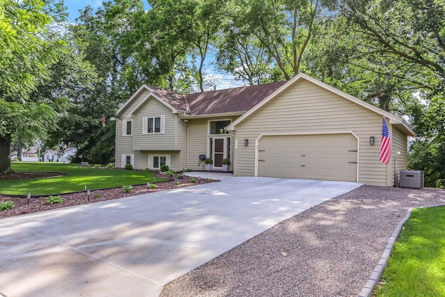 2583 Lost Lake Rd, Mound, MN 55364 - split level home with concrete driveway, a front yard, a garage, and a shingled roof