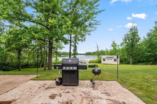 3718 Big Mcgraw Rd, Blaine Twp, WI 54830 - view of patio with area for grilling, a water view, an outdoor structure, and an outdoor fire pit