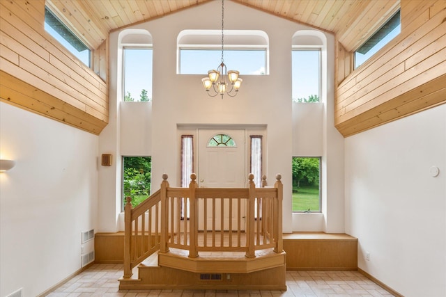 3718 Big Mcgraw Rd, Blaine Twp, WI 54830 - entrance foyer with high vaulted ceiling, plenty of natural light, a chandelier, brick patterned flooring, and wooden ceiling