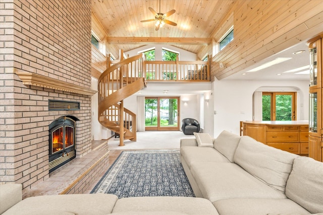 3718 Big Mcgraw Rd, Blaine Twp, WI 54830 - living area with a fireplace, high vaulted ceiling, stairway, a ceiling fan, and a wood ceiling with exposed beams