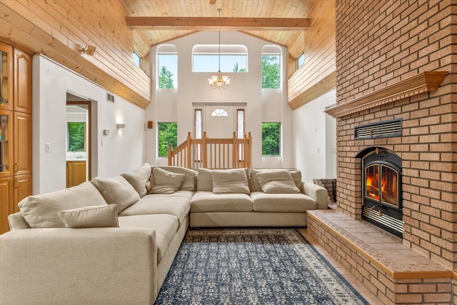 3718 Big Mcgraw Rd, Blaine Twp, WI 54830 - living area with a chandelier, high vaulted ceiling, plenty of natural light, a wood ceiling with exposed beams, and a brick fireplace