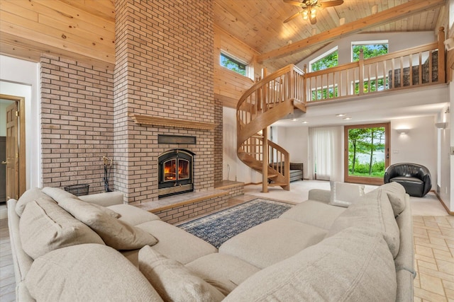 3718 Big Mcgraw Rd, Blaine Twp, WI 54830 - living area with high vaulted ceiling, wooden ceiling, a fireplace, stairs, and healthy amount of natural light