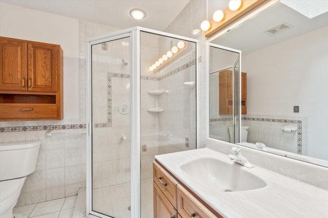 3718 Big Mcgraw Rd, Blaine Twp, WI 54830 - bathroom with tile walls, vanity, a stall shower, tile patterned flooring, and a wainscoted wall