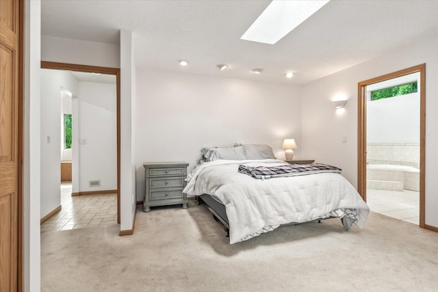 3718 Big Mcgraw Rd, Blaine Twp, WI 54830 - bedroom featuring light carpet, a skylight, connected bathroom, and light tile patterned floors
