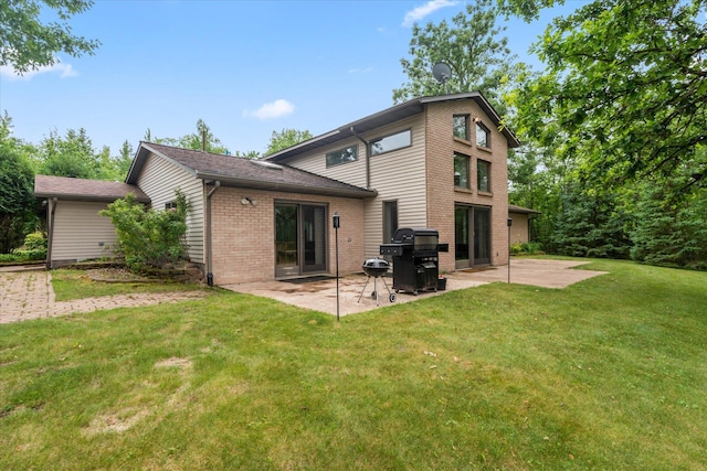 3718 Big Mcgraw Rd, Blaine Twp, WI 54830 - back of house with brick siding, a patio, and a lawn