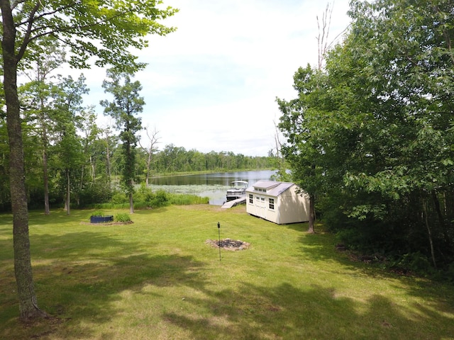 3718 Big Mcgraw Rd, Blaine Twp, WI 54830 - view of grassy yard with a water view, a dock, and an outdoor structure