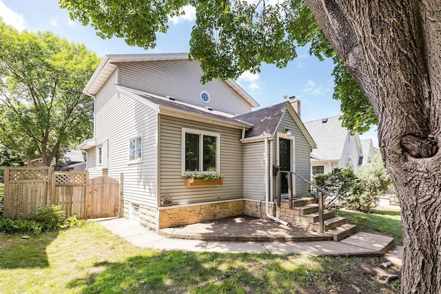 4716 30th Ave S, Minneapolis, MN 55406 - back of house with a shingled roof and a patio