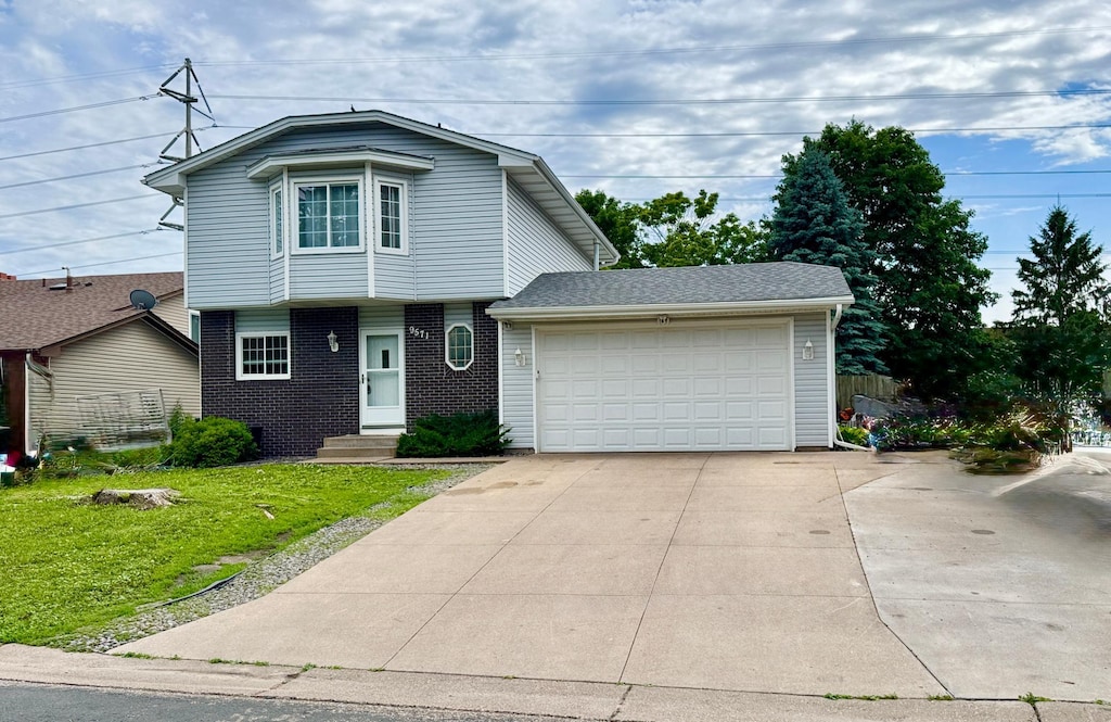 9571 97th Pl N, Maple Grove, MN 55369 - view of front facade featuring a front lawn, a garage, and brick siding