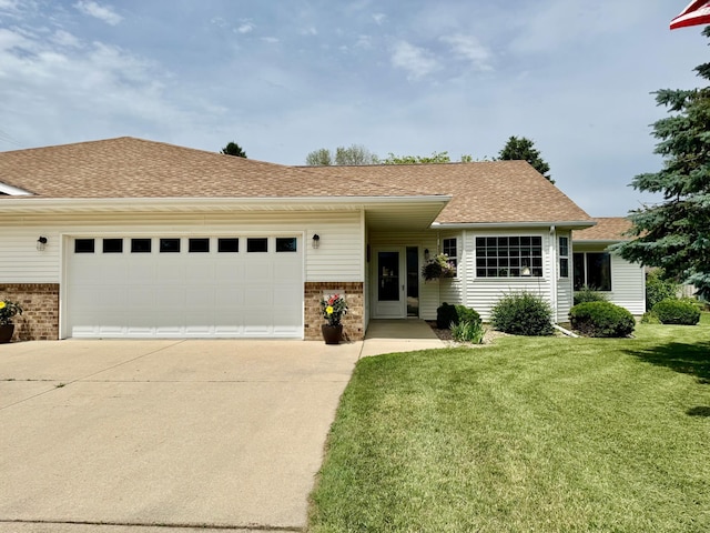 332 4th St SW, Blooming Prairie, MN 55917 - view of front of house with brick siding, driveway, a garage, a front lawn, and roof with shingles