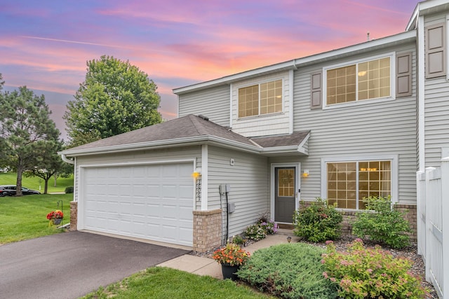 16063 71st Ln NE, Otsego, MN 55330 - traditional-style home with a garage, asphalt driveway, roof with shingles, and a front lawn
