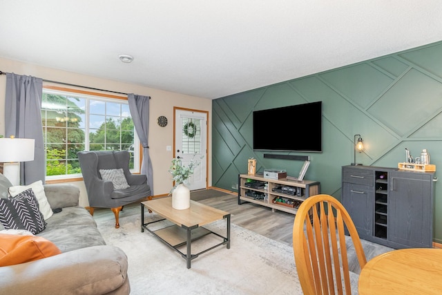 16063 71st Ln NE, Otsego, MN 55330 - living area featuring light wood-type flooring, an accent wall, and a decorative wall