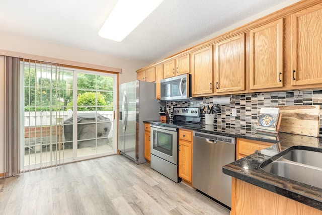 16063 71st Ln NE, Otsego, MN 55330 - kitchen featuring appliances with stainless steel finishes, light wood finished floors, backsplash, and light brown cabinets