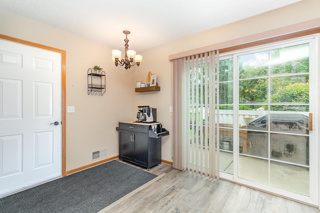 16063 71st Ln NE, Otsego, MN 55330 - doorway to outside with light wood-type flooring and a chandelier