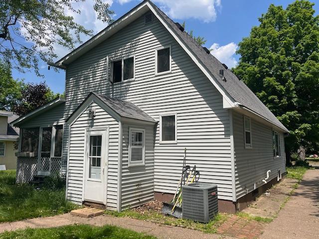 241 S Street W, Amery, WI 54001 - back of property featuring a sunroom and a shingled roof