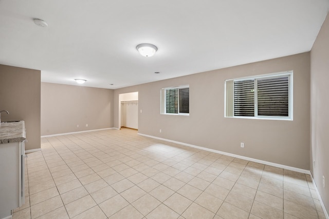 1011 6th Ave NE, Buffalo, MN 55313 - unfurnished room featuring light tile patterned floors and a smoke detector