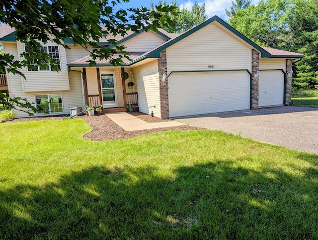 1541 282nd Ln NW, Isanti Twp, MN 55040 - split level home with asphalt driveway, an attached garage, and a front lawn