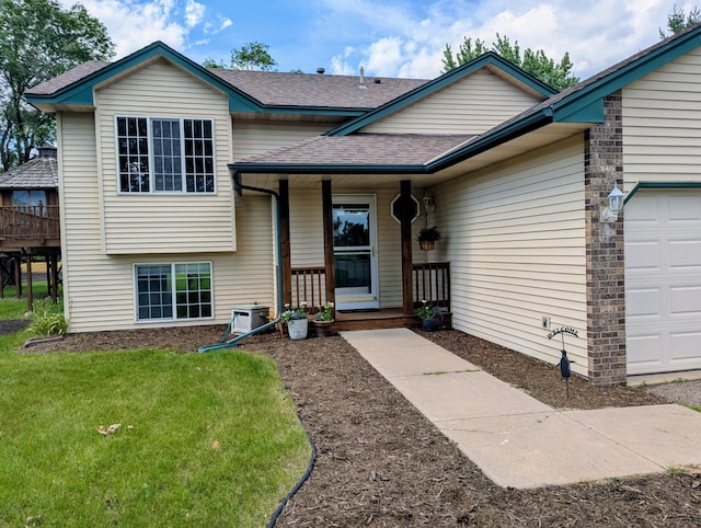 1541 282nd Ln NW, Isanti Twp, MN 55040 - split level home with roof with shingles, a porch, a front yard, and an attached garage