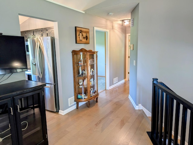 1541 282nd Ln NW, Isanti Twp, MN 55040 - hall featuring light wood-style floors and an upstairs landing