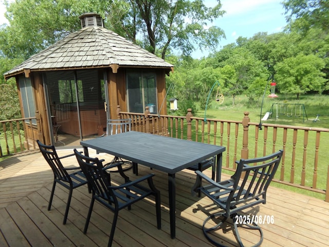 1541 282nd Ln NW, Isanti Twp, MN 55040 - wooden deck featuring a gazebo, outdoor dining area, a lawn, and a playground