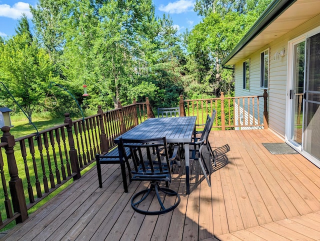 1541 282nd Ln NW, Isanti Twp, MN 55040 - deck featuring outdoor dining space, a yard, and view of scattered trees