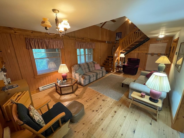 31519 243rd Ave, Moose Creek Twp, MN 56676 - living room with wooden walls, stairway, wood-type flooring, a chandelier, and baseboard heating