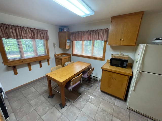 31519 243rd Ave, Moose Creek Twp, MN 56676 - kitchen featuring freestanding refrigerator, black microwave, healthy amount of natural light, and light tile patterned floors