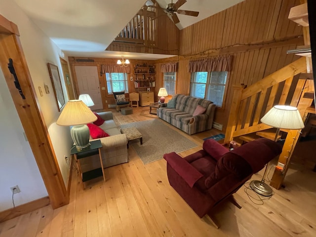 31519 243rd Ave, Moose Creek Twp, MN 56676 - living room with high vaulted ceiling, wood walls, wood-type flooring, and ceiling fan
