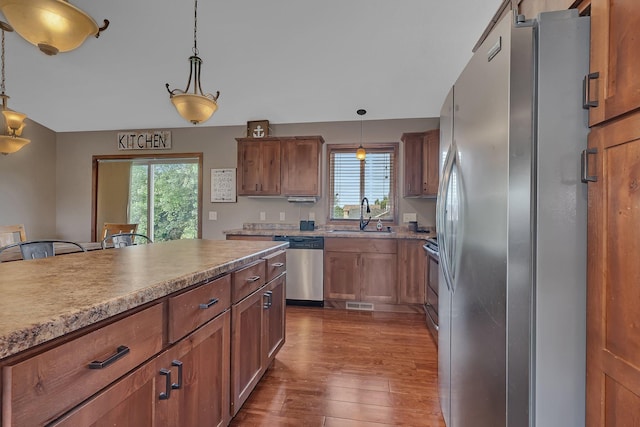 617 Knights Ct, Sartell, MN 56377 - kitchen with stainless steel appliances, dark wood-type flooring, healthy amount of natural light, and hanging light fixtures