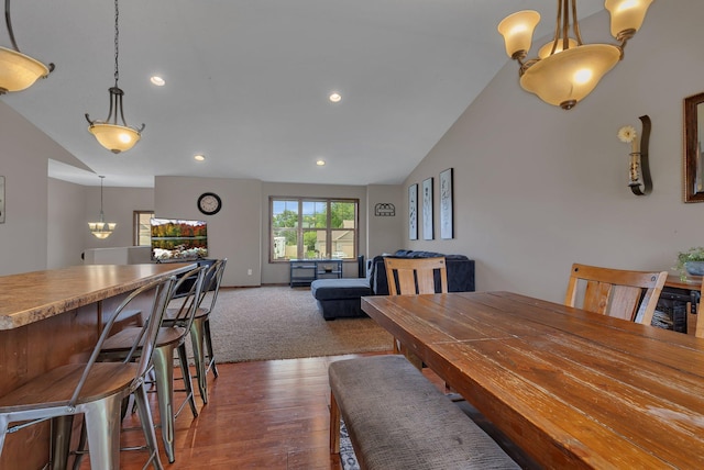 617 Knights Ct, Sartell, MN 56377 - dining space with lofted ceiling, a chandelier, dark wood-style flooring, and recessed lighting