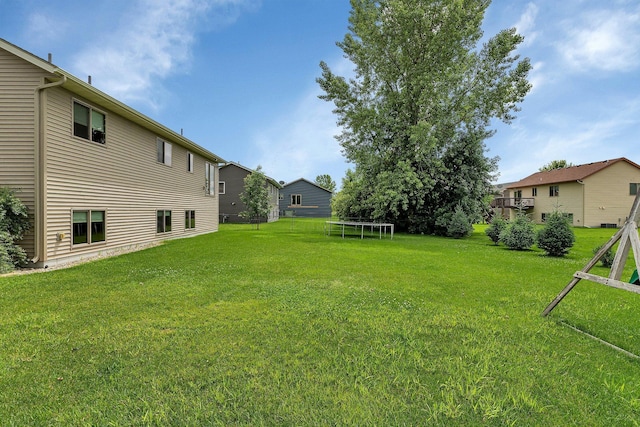 617 Knights Ct, Sartell, MN 56377 - view of grassy yard featuring a trampoline