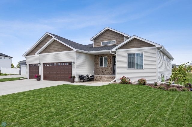 2548 Golden Valley Pkwy S, Fargo, ND 58104 - craftsman house featuring a front yard, an attached garage, concrete driveway, and brick siding