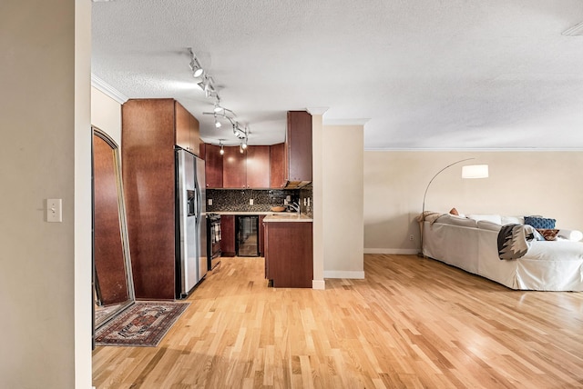 2800 44th St Unit 608, Minneapolis, MN 55410 - kitchen featuring open floor plan, stainless steel fridge, rail lighting, light wood-type flooring, and crown molding
