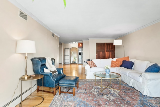 2800 44th St Unit 608, Minneapolis, MN 55410 - living room with a baseboard heating unit, wood finished floors, and crown molding