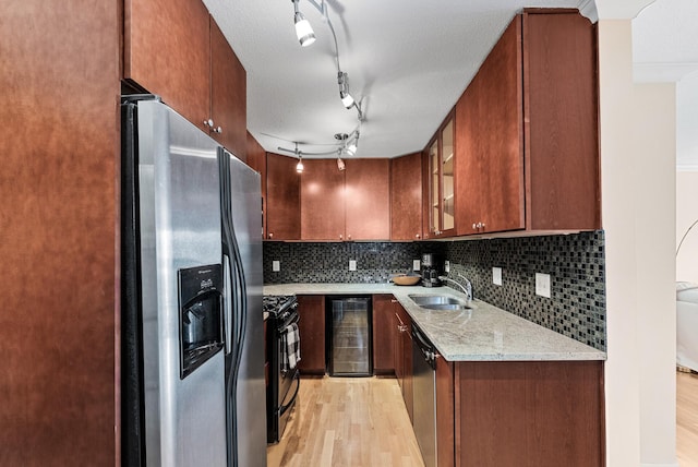 2800 44th St Unit 608, Minneapolis, MN 55410 - kitchen featuring stainless steel appliances, light wood finished floors, wine cooler, glass insert cabinets, and a textured ceiling