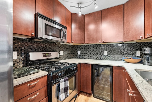 2800 44th St Unit 608, Minneapolis, MN 55410 - kitchen featuring stainless steel appliances, wine cooler, tasteful backsplash, and light stone countertops