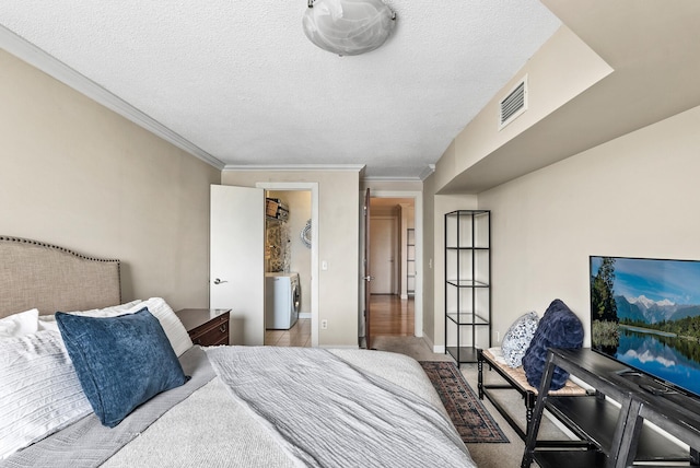 2800 44th St Unit 608, Minneapolis, MN 55410 - bedroom with washer / dryer, ornamental molding, and a textured ceiling