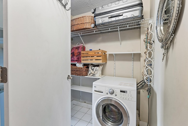 2800 44th St Unit 608, Minneapolis, MN 55410 - laundry area featuring washer / dryer, tile patterned floors, and a textured ceiling