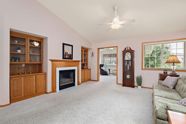 13019 Brookside Ln N, Rogers, MN 55374 - living area featuring light colored carpet, vaulted ceiling, a ceiling fan, plenty of natural light, and a high end fireplace