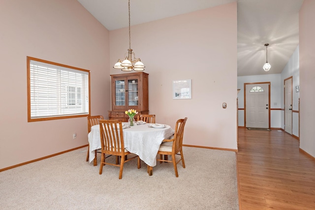 13019 Brookside Ln N, Rogers, MN 55374 - dining room featuring a chandelier, high vaulted ceiling, and light wood finished floors