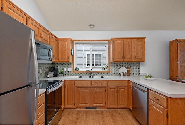 13019 Brookside Ln N, Rogers, MN 55374 - kitchen with stainless steel appliances, a peninsula, light wood-style flooring, decorative backsplash, and light countertops