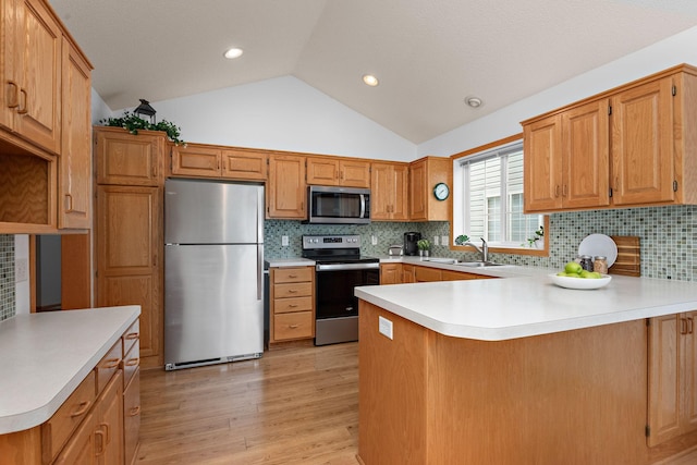 13019 Brookside Ln N, Rogers, MN 55374 - kitchen with appliances with stainless steel finishes, a peninsula, lofted ceiling, light wood-style floors, and light countertops